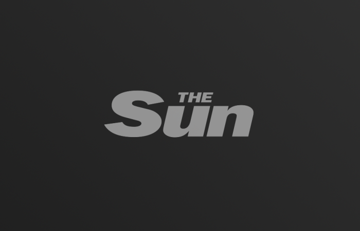 The Sun logo on dark gradient background