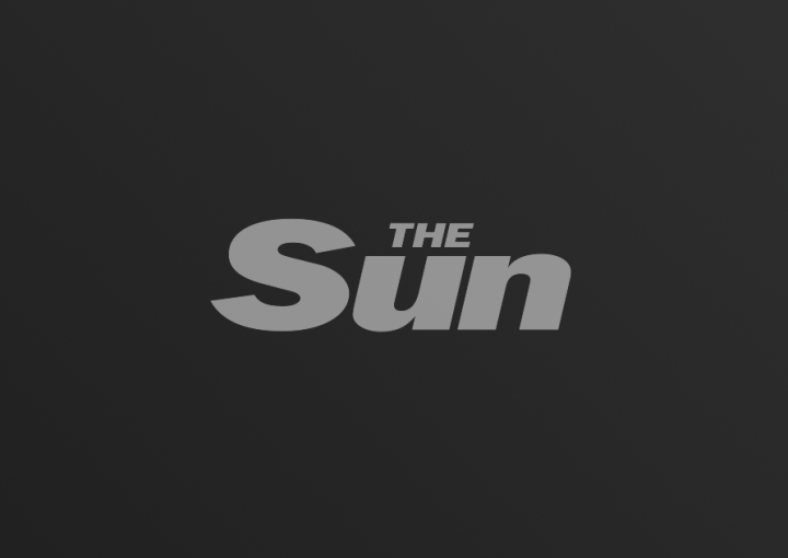 The Sun logo on dark gradient background