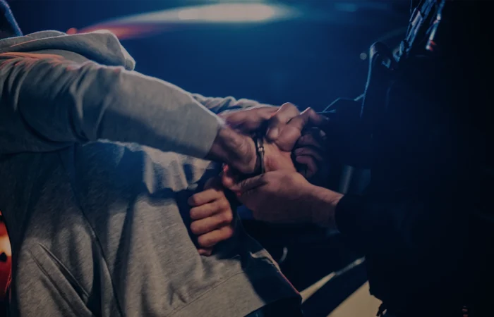 officer violently pushing man against the car and handcuffing him