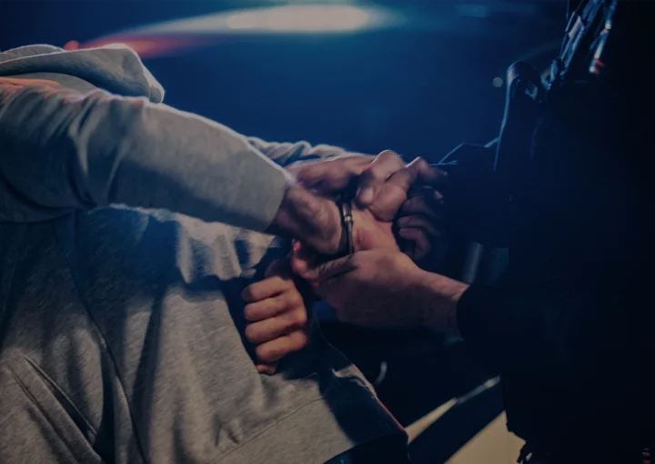 officer violently pushing man against the car and handcuffing him