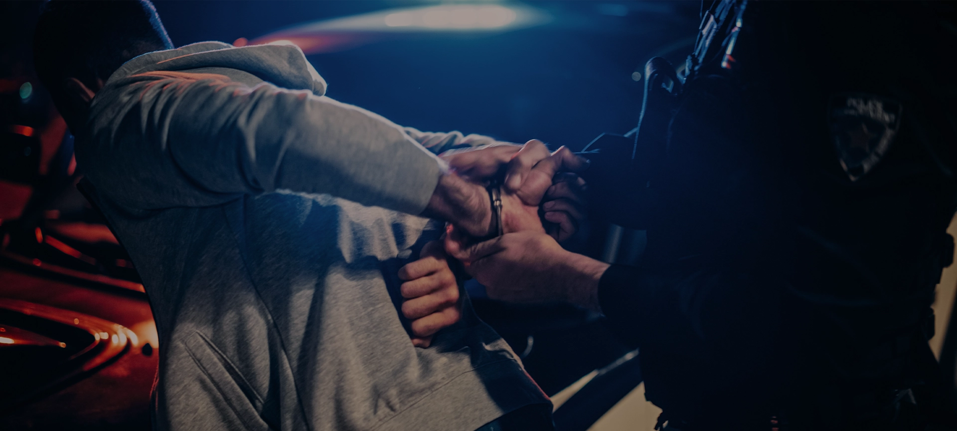 officer violently pushing man against the car and handcuffing him