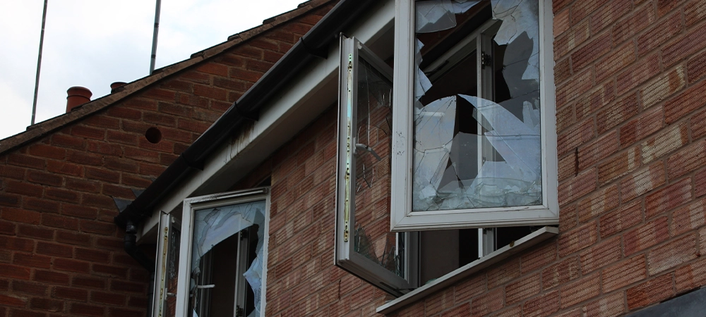 abandoned house with two open smashed windows