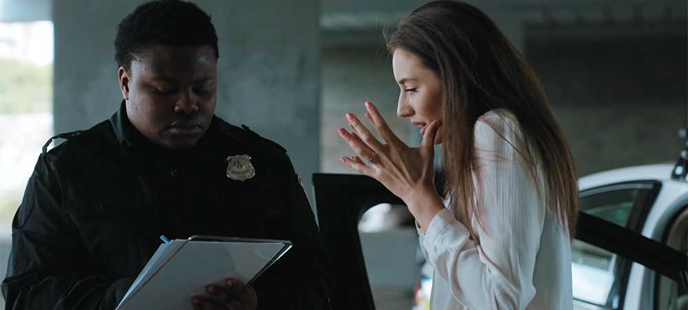 Portrait frightened woman talk with policeman about an incident arrest criminal enforcement burglar man officer black bad robbery business busted illegal slow motion