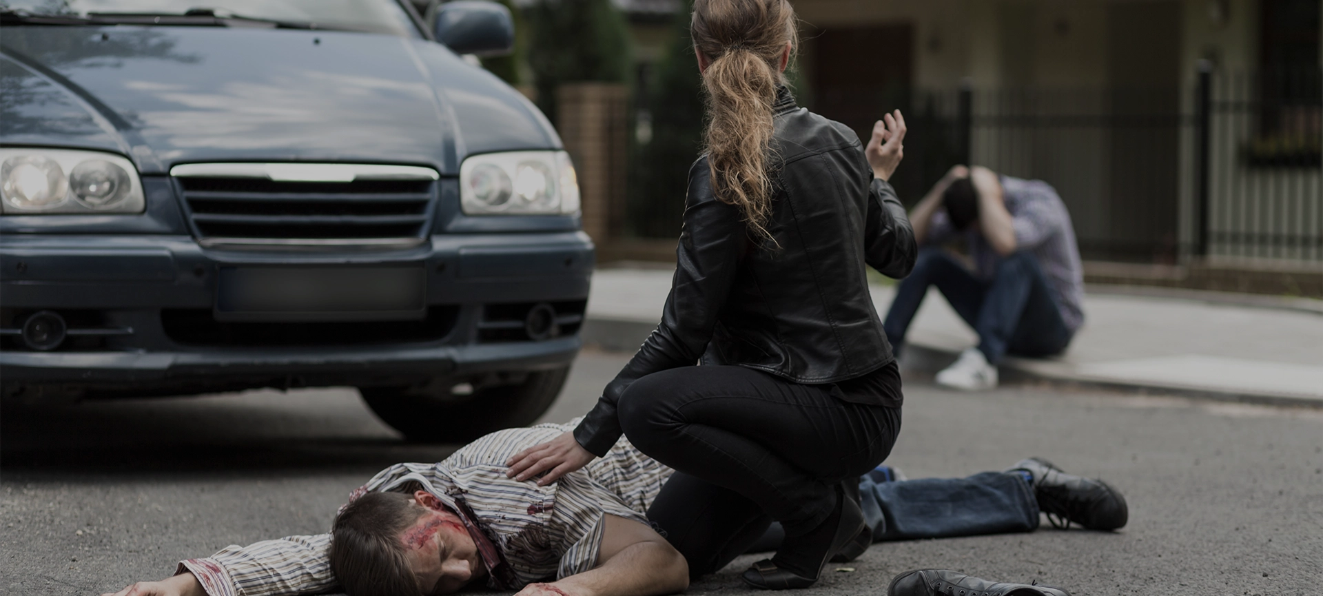 Bloody victim of car accident lying on the street