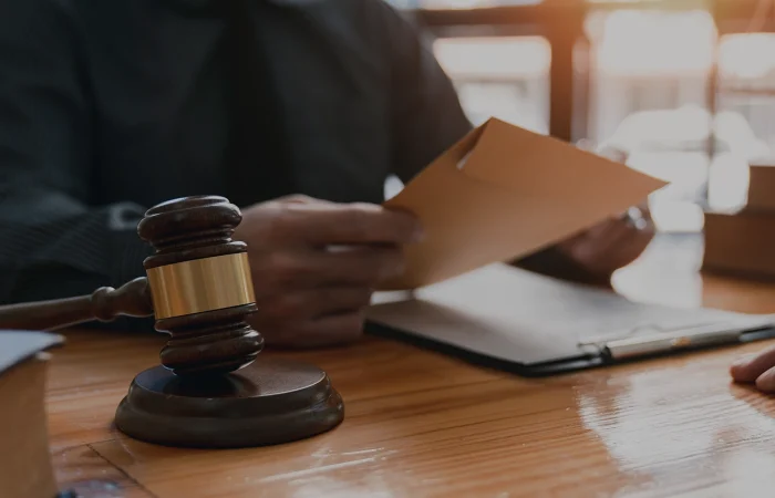 lawyer or attorney who is taking bribes reads the statute of limitations. Consultation between male lawyers and business clients, tax and legal services and corruption firms.