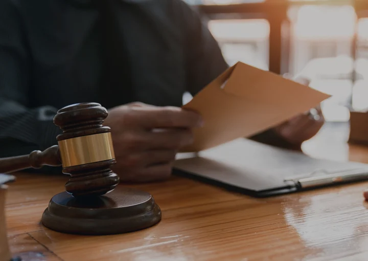 lawyer or attorney who is taking bribes reads the statute of limitations. Consultation between male lawyers and business clients, tax and legal services and corruption firms.