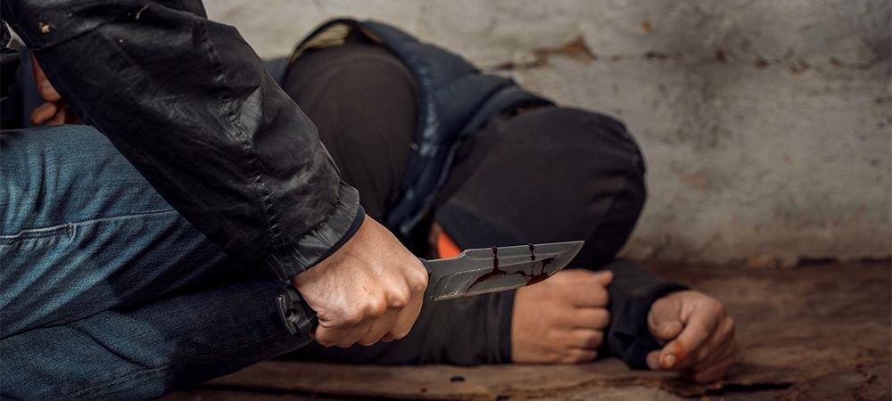 Murder and the concept of people-the criminal or murderer with a knife in the blood and the dead body of a man lying on the floor at the crime scene