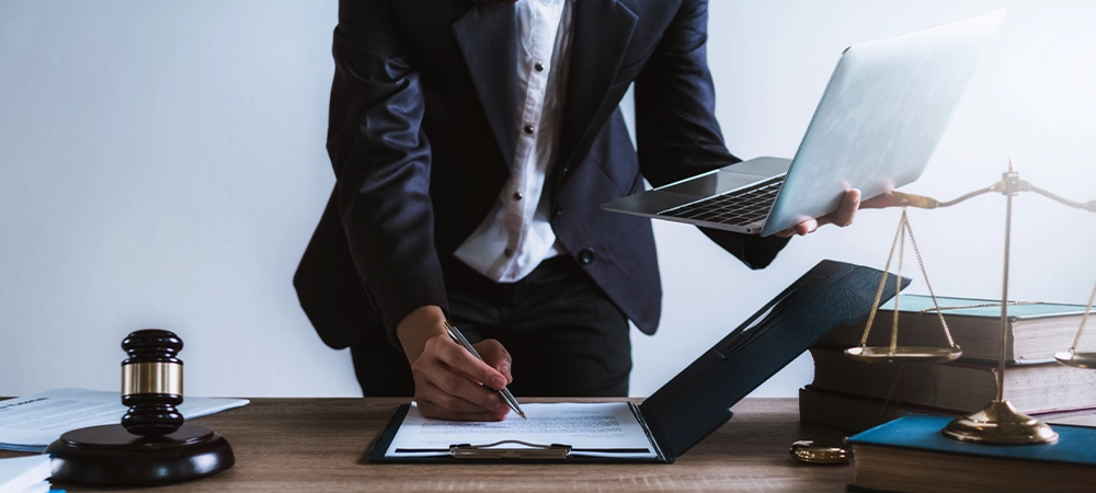 Lawyer or business woman using laptop with contact papers on table in office. wooden gavel justice and law ,attorney, court judge, concept.