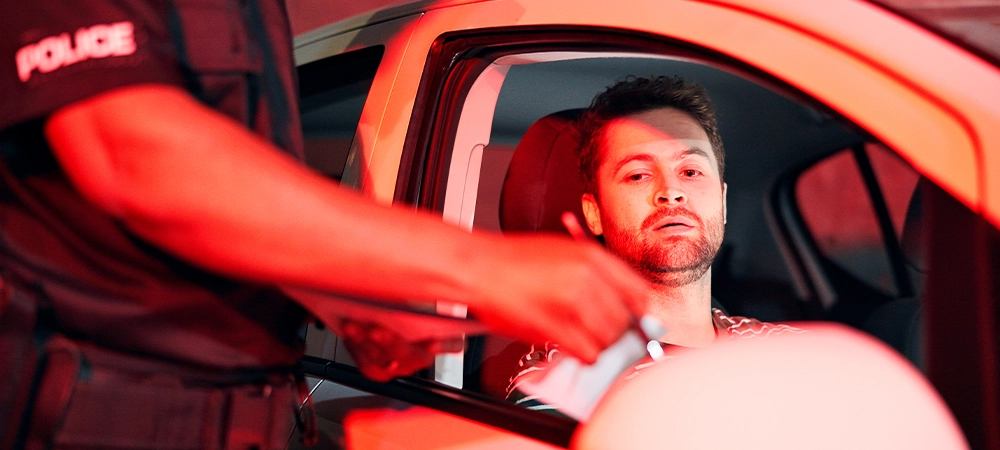 Man, police and stop car at night for speeding ticket, registration check and traffic warning. Person, law enforcement and licence crime of drunk driving, fine penalty and transport risk of violation