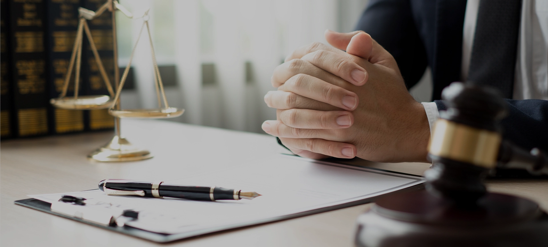 The lawyers sitting in their office is meticulously examining the judicial documents to gather crucial information and build a strong legal strategy for their client's case.