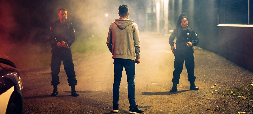 Two Police Officers Catch and Arrest Suspect. Heroic Officers of the Law Tackle and Stop Dangerous Criminal on the Dark City Street. Cops Arresting Felon, Fight Crime. Dramatic Cinematic Shot