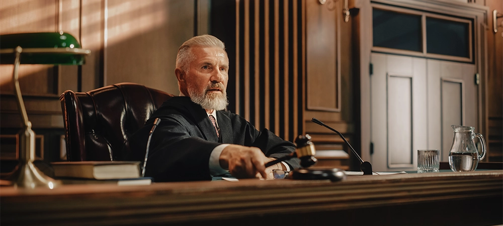 Court of Law Trial: Portrait of Impartial Judge Reading Decision, striking Gavel. Justice Pronouncing Sentence. Judgment after Deliberation. Guilty, Not Guilty Verdict. Cinematic Concept Rule of Law