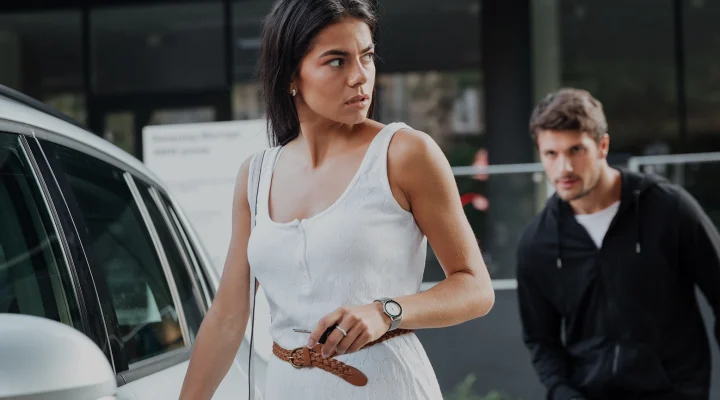 Dangerous young man robber stalking to young woman opening her car