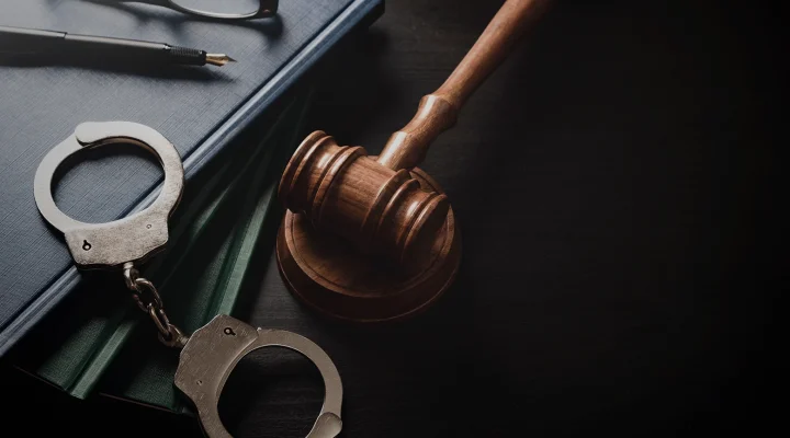 Handcuffs and wooden gavel. Crime and violence.